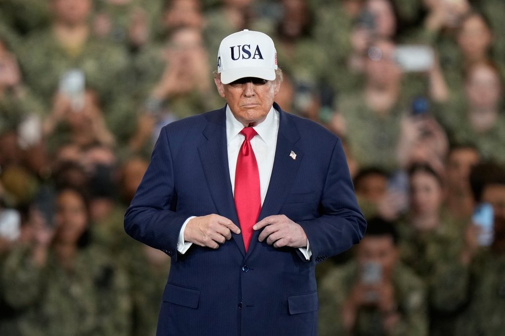 U.S. President Donald Trump arrives to meet with soldiers and servicemen at the USS George Washington at the U.S. Navy's Yokosuka base in Yokosuka, south of Tokyo, Tuesday, Oct. 28, 2025. (AP Photo/Eugene Hoshiko).