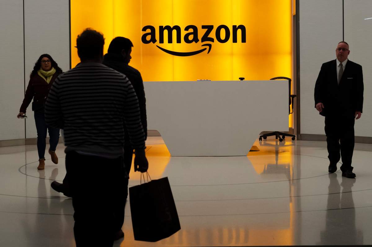 People walk into the lobby for Amazon offices Thursday, Feb. 14, 2019, in New York.