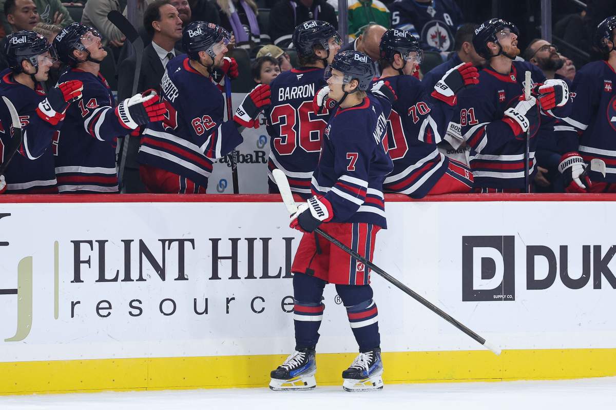 Winnipeg Jets center Vladislav Namestnikov (7) is congratulated for his goal against the Minnesota Wild during the first period of an NHL hockey game Tuesday, Oct. 28, 2025, in St. Paul, Minn. (AP Photo/Matt Krohn).