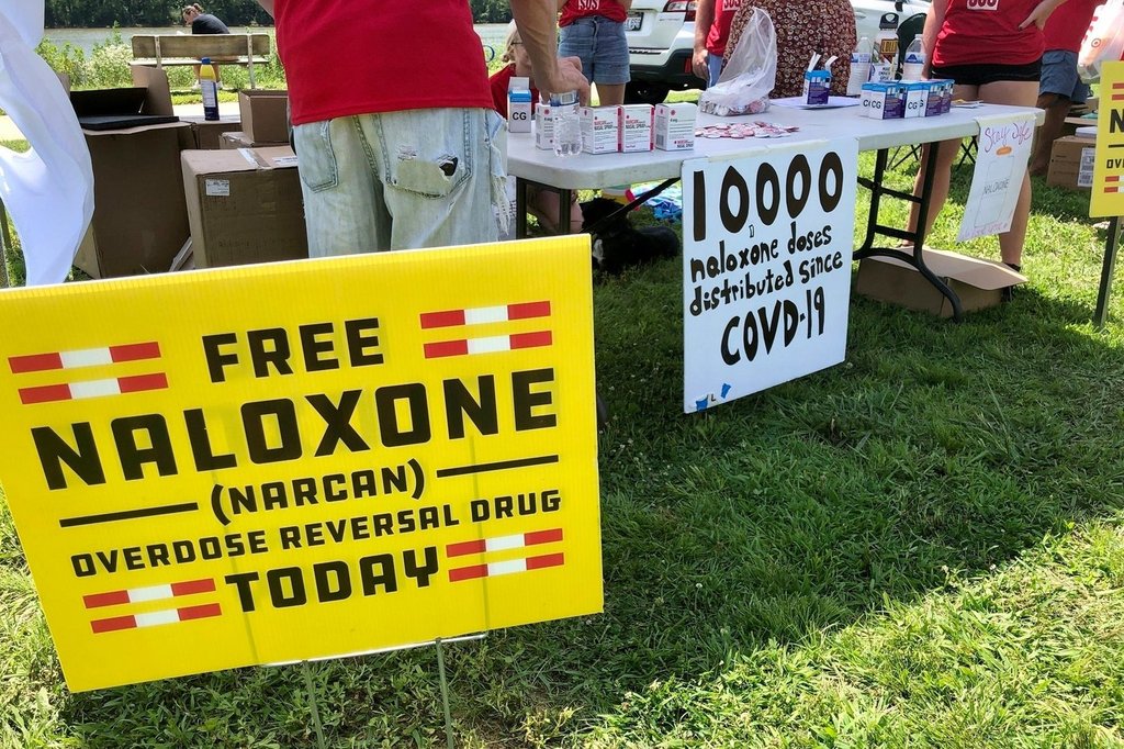 FILE - Signs are displayed at a tent during a health event June 26, 2021, in Charleston, W.Va. (AP Photo/John Raby, File).